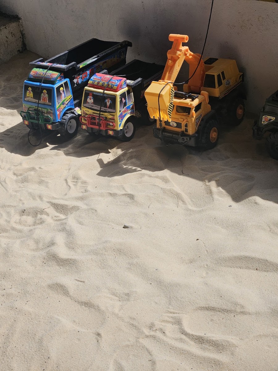Remote-control diggers and toy trucks in the RC Diggers Land sandpit